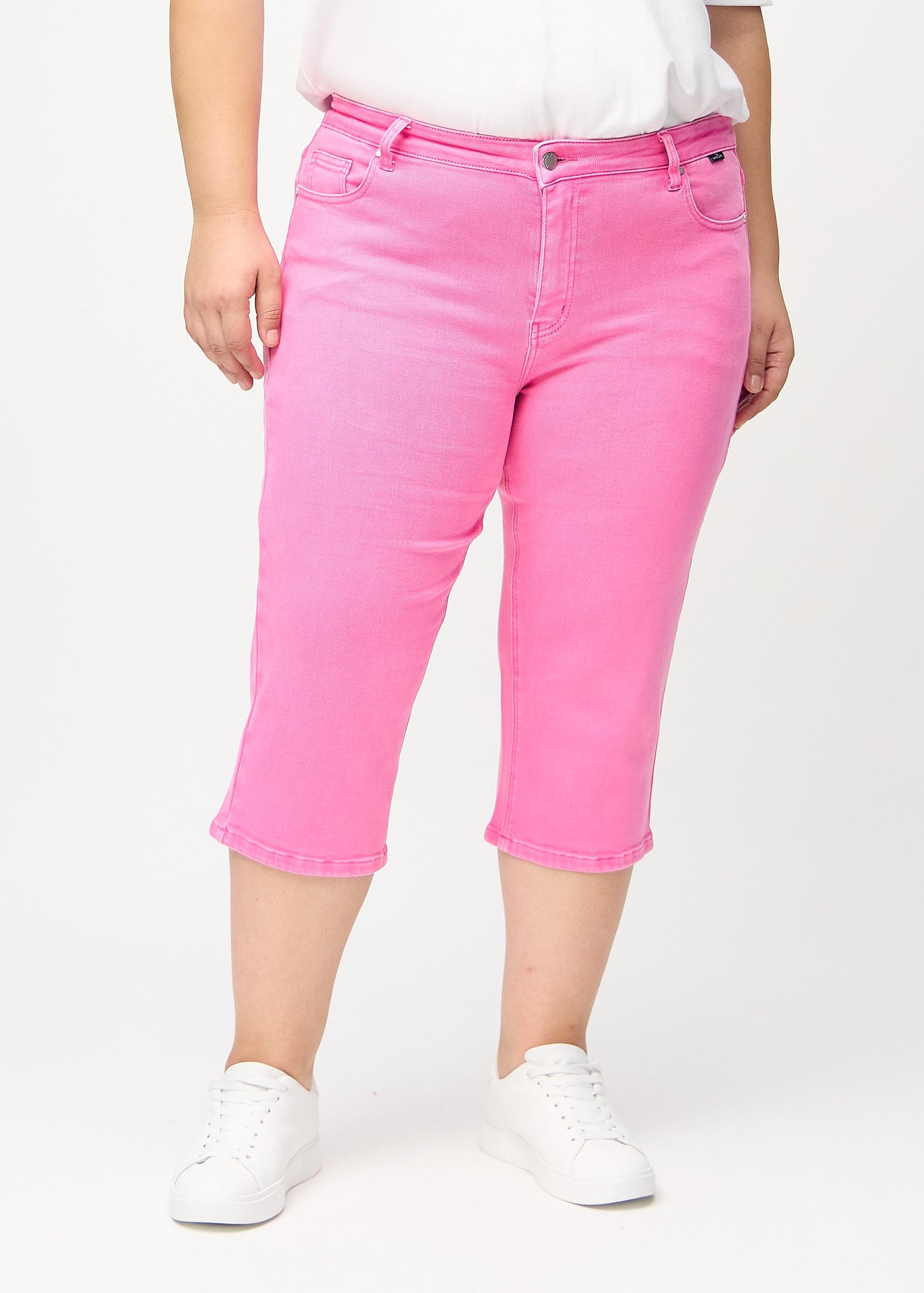 Lyserøde regular capris, modelnavn Flamingos, som går lige ned langs benet på en plus-size model, set forfra.